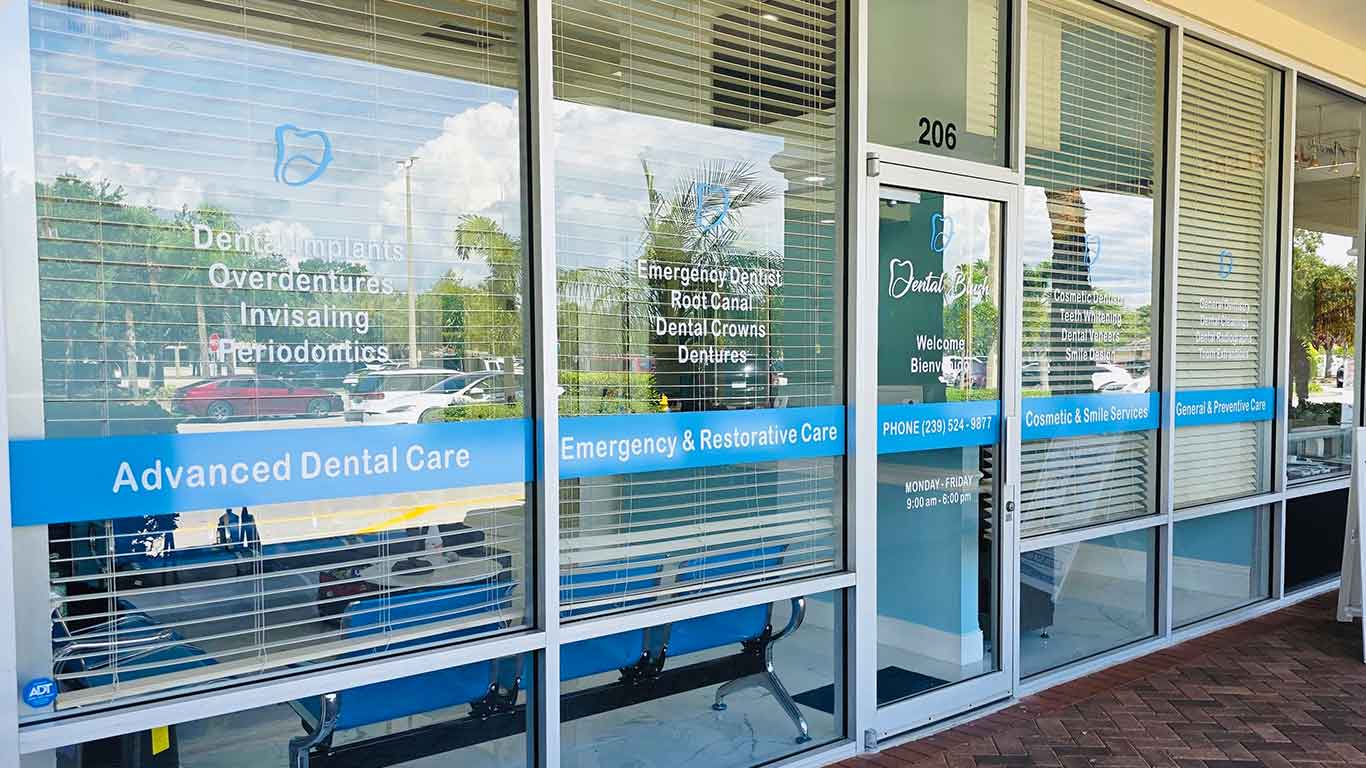 Dental Blush storefront in Bonita Springs with blue window signage and the glass entrance to Suite 206