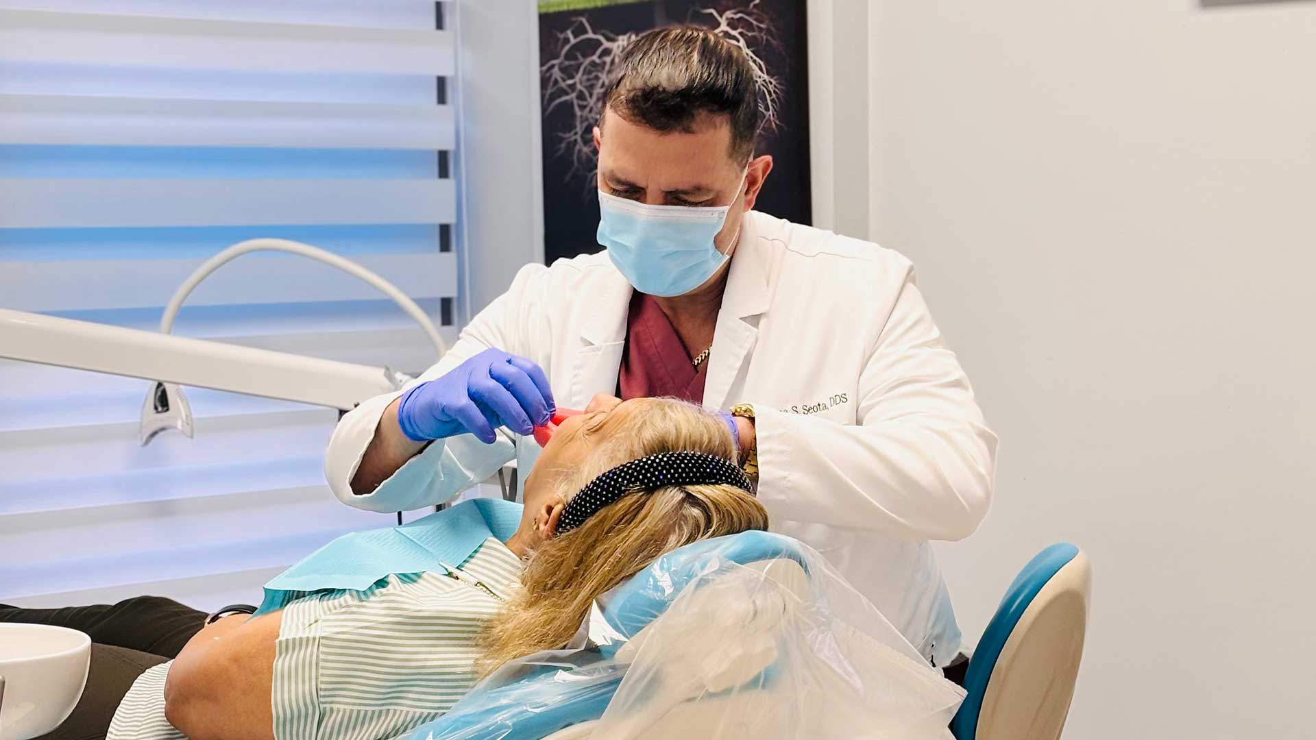 Overdentures in Miami Overdentures in Miami with dentist treating a patient at Dental Blush Tamiami