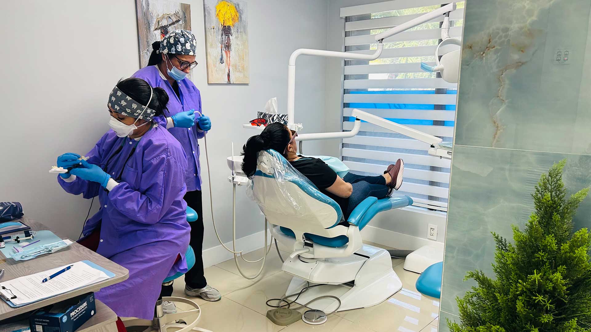 Dental team assisting a patient during a dentist appointment at Dental Blush Tamiami