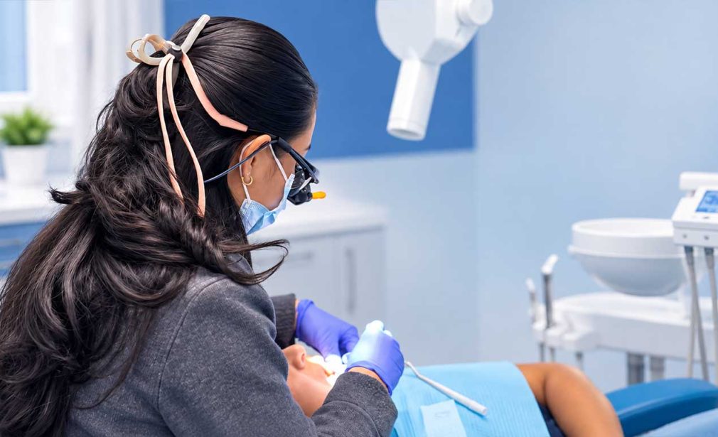 Dr. Geraldine Pullas providing dental care to a patient at Dental Blush in Miami