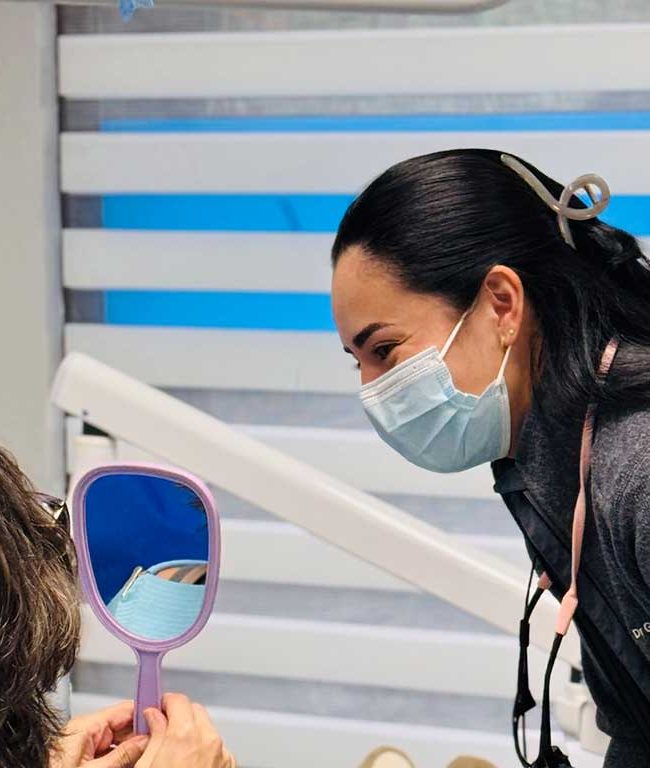 Dr. Geraldine Pullas speaking with a patient at Dental Blush