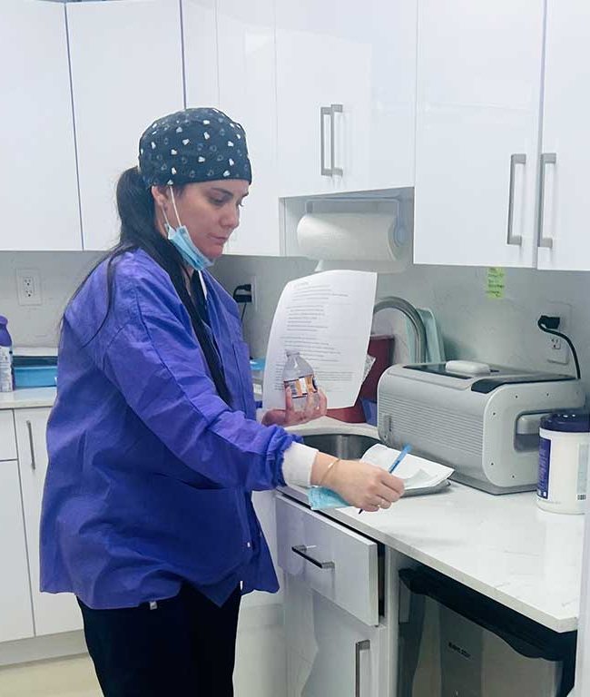 Katia Roman Chavez working in the sterilization area at Dental Blush