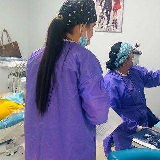 Dental team evaluating a patient for wisdom tooth removal in Miami